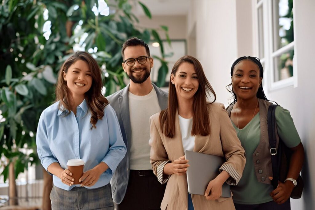 a group of people standing smiling about us